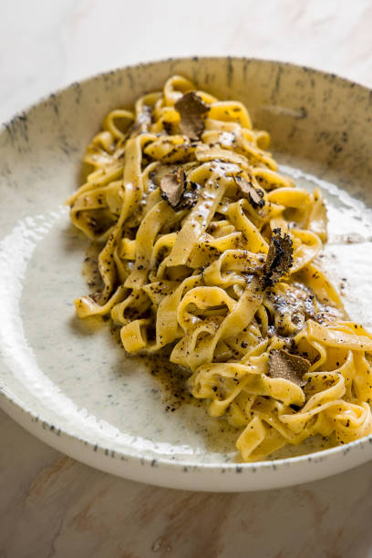 istock tagliatelli pasta with black truffle on marble table vertical macro close up 1452586360