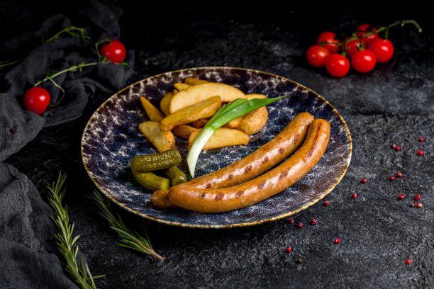istock turkey sausages on a plate with potato wedges on dark table 1452586944