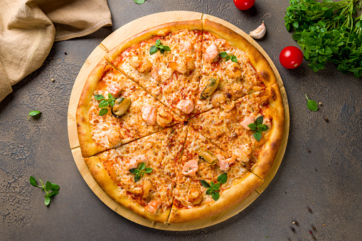 Pizza with seafood and tomato sauce top view