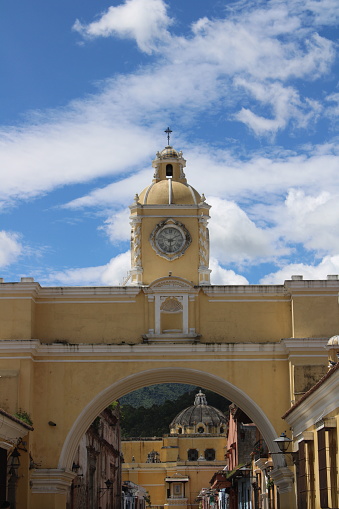 This yellow arc is a famous spot in Guatemala to take pictures, it is surrounded by culture and natural beauty.