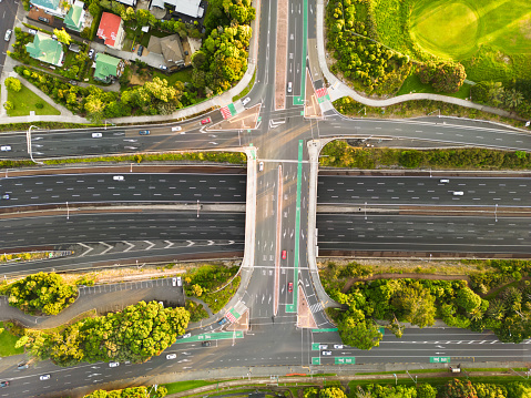 Drone aerial view of multiple lane highway of a modern city during day.