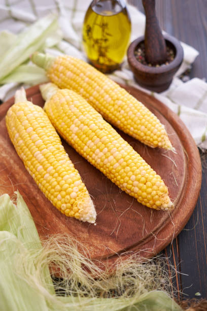 istock Organic natural corn cobs on wooden kitchen table 1452597422