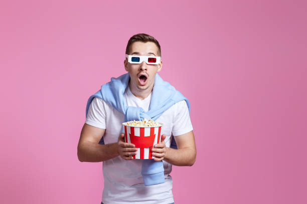 istock scared man in 3d glasses holding bucket of popcorn 1452597710
