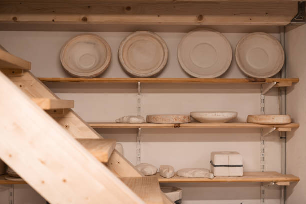 istock Various handmade ceramic empty jars on shelves in a small business 1452598479