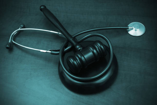 istock Judge gavel and stethoscope on wooden table. 1452600436