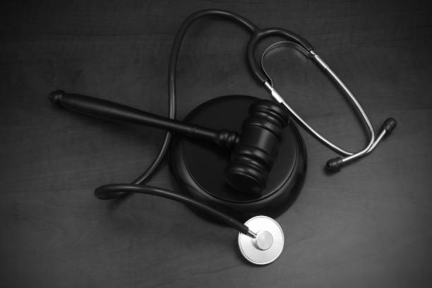 istock Judge gavel and stethoscope on wooden table. 1452600491