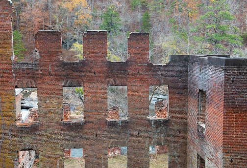 Ruins of the New Manchester Manufacturing Company textile mill set against the fall leaves along Sweetwater Creek in Lithia Springs, Georgia. The mill was burned during the Civil War and was built by slave labor.