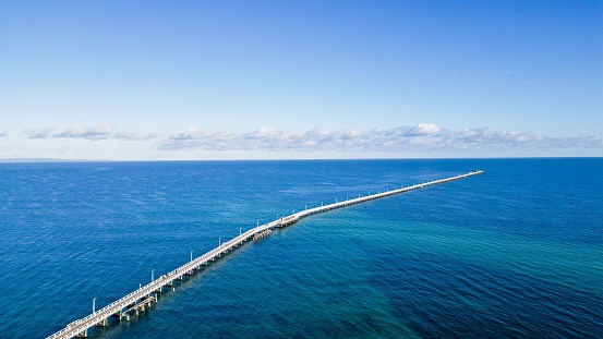 An aerial view of the Busselton Jetty on a sunny day in Busselton, Australia