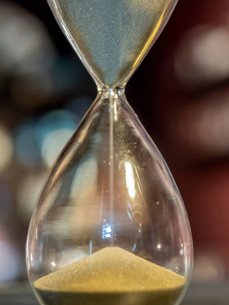 Sand timer hourglass in operation stock photo