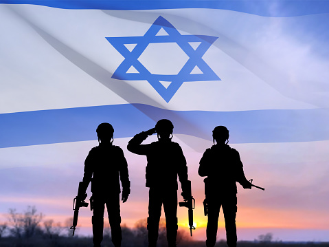 Silhouette of soldier with Israel flag against the sunrise. Concept - armed forces of Israel