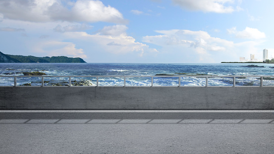 Asphalt road with ocean view and blue sky background