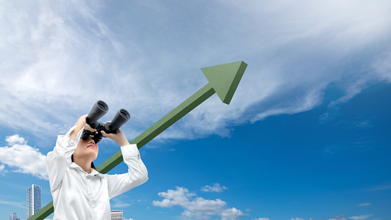 Asian businesswomen with binoculars looking at increasing arrows in the sky