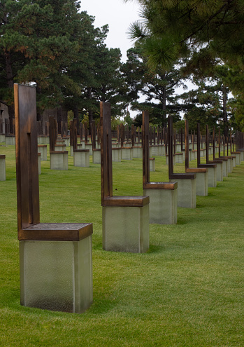 Long row of chairs in the Field of Empty Chairs at the Oklahoma City National Memorial Museum. Each chair signifies a person killed in the bombing.