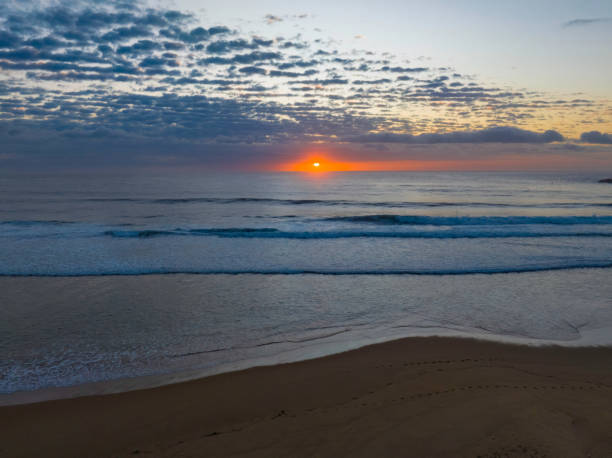 istock Beautiful sunrise with clouds over the ocean 1452624211