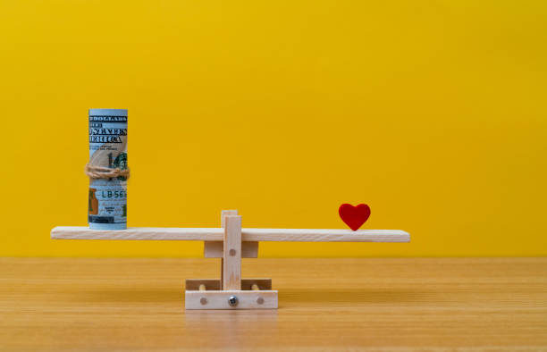 istock Seesaw with red heart and American dollar 1452624284
