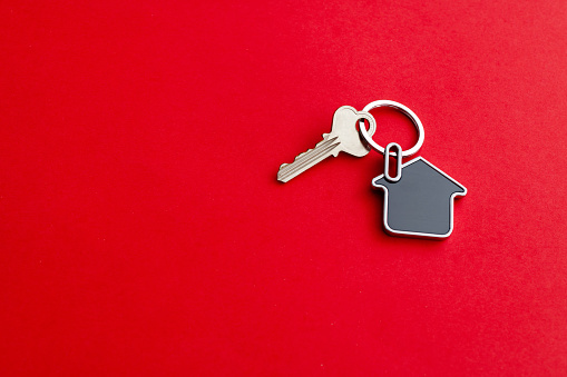 House key on red background.