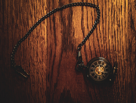 Vintage pocket watch on black background