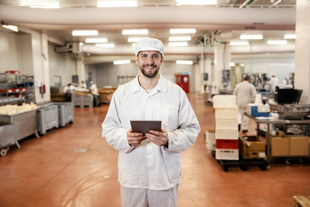 istock A meat industry supervisor holds the tablet in his hands and smiles at the camera while checking on meat quality. 1452633266