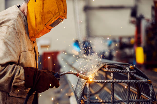 istock Close up of a heavy industry worker using a welding machine for metal construction in the factory. 1452633366