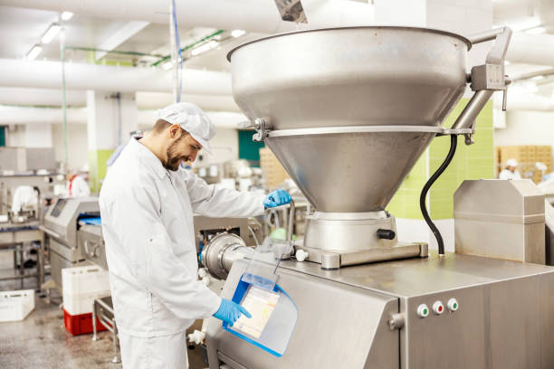 istock A meat factory worker is managing meat grinding machine and pressing touch screen. 1452634299