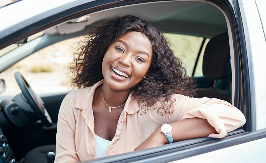 Black woman, car and smile of a relax person from Jamaica on a road trip with motor transport. Portrait of a happy, vehicle and relax female enjoying a summer day with transportation travel