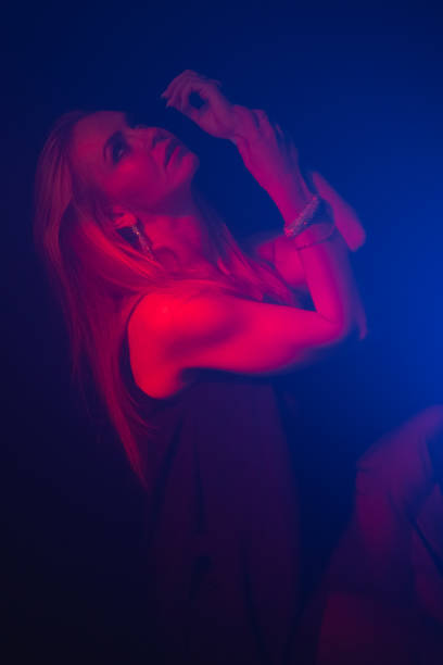 istock Attractive woman illuminated with red light on black background 1452642879