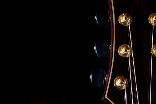 A selective-focus shot of guitar headstocks.
