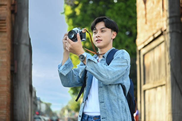 istock Man taking photo with digital camera standing at Tha Phae Gate is a major tourist attraction in Chiang Mai northern Thailand. 1452646714