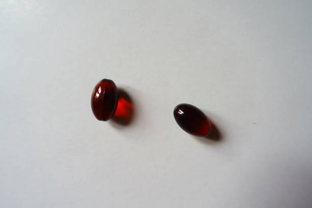 istock Two red softgel capsules of krill oil 1452648256