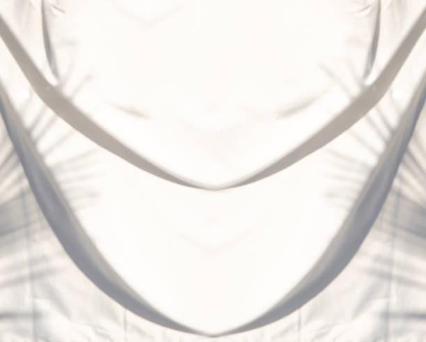 istock Blurred artistic abstract background of white fabric waves and shadows from morning sunlight. 1452648849