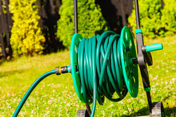 istock Garden hose for watering plants in garden 1452650166