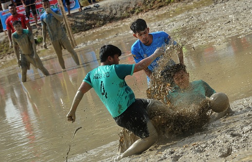 MALAYSIA, The Ngoca soccer team waded through the mud to grab the ball while participating in the 2022 Negeri Sembilan Ngoca Festival in Terachi Cultural Village, Kuala Pilah.