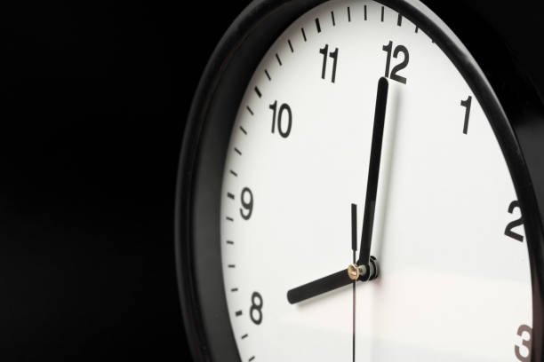istock Alarm clock close up on black background 1452650748