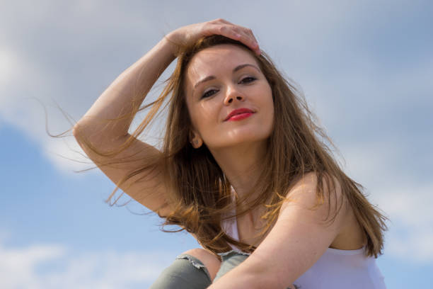 istock Brown long hair blowing in the wind against sky. 1452651626