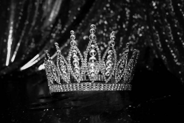 istock Royal crown on luxury satin, sparkle fabric background 1452651749