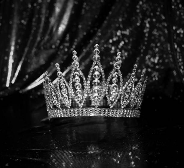 istock Royal crown on luxury satin, silk fabric background. Black and white. 1452651751