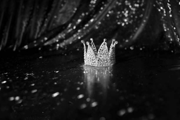 istock Royal crown on luxury satin, silk fabric background. Black and white. 1452651753