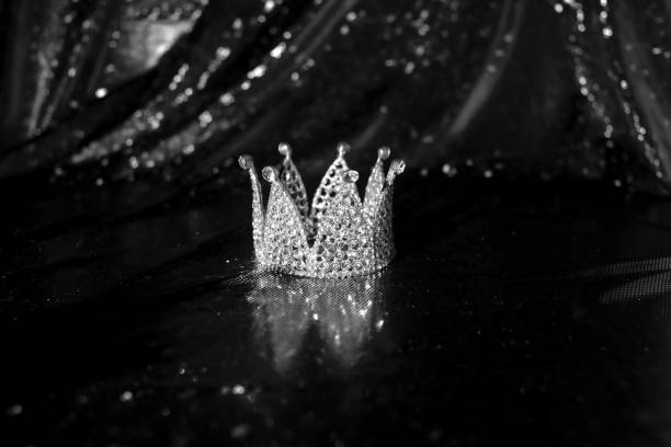 istock Royal crown on luxury satin, silk fabric background. Black and white 1452651754