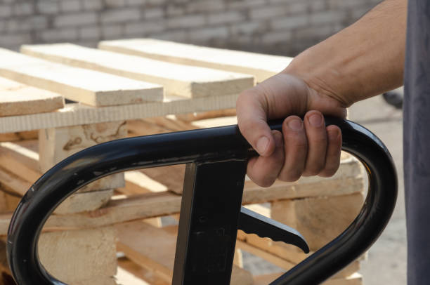 Pallet jack. Keep the handle of the rohli, loading on the rohle Keep the handle of the rohli, loading on the rohle. High quality photo pallet jack handle stock pictures, royalty-free photos & images