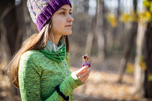 Gorgeous girl eating protein bar