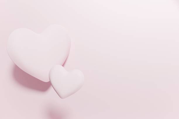 istock 3d render of two flying hearts on a pastel pink background 1452656706