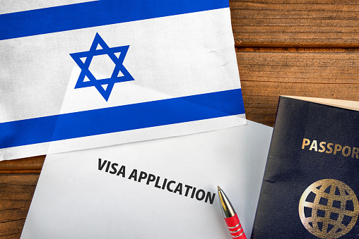 Visa application form, passport and flag of Israel