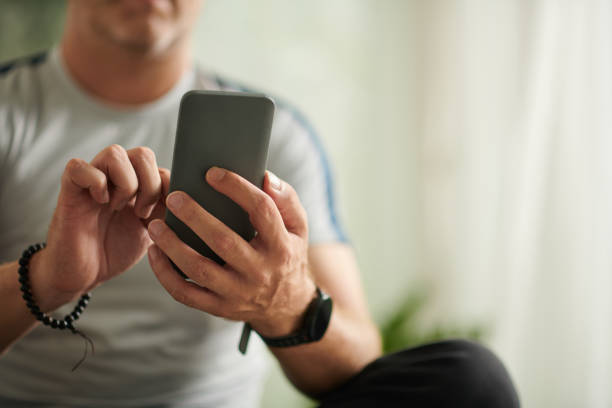 istock Man Calling Online Fitness Instructor 1452658390