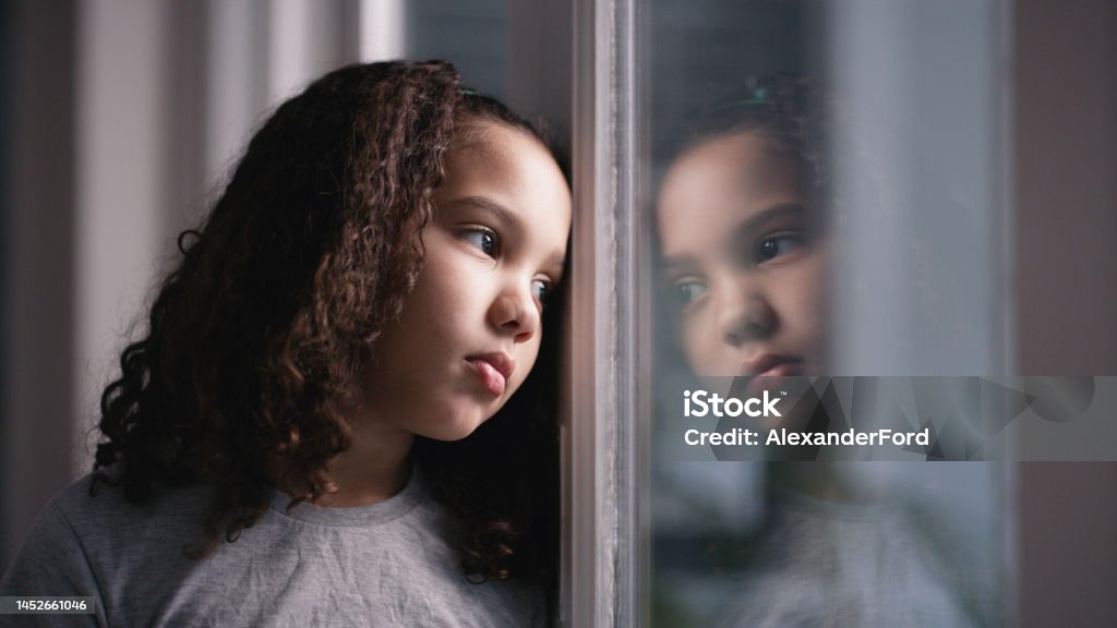 Mental health, girl and window for sad, thinking and depressed in home. Depression, black child and unhappy with stress, anxiety and frustrated with suffering, disappointed and foster female kid. Mental health, girl and window for stress, thinking and depressed in home. Depression, black child and unhappy looking sad, anxiety and frustrated with suffering, disappointed and foster female kid. Child Stock Photo