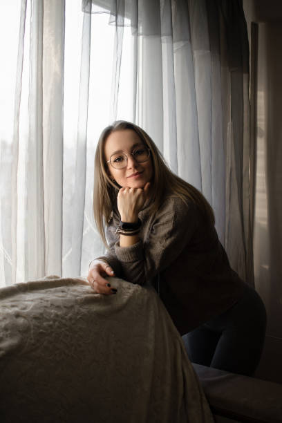 istock beautiful young woman in a cozy home environment 1452661283