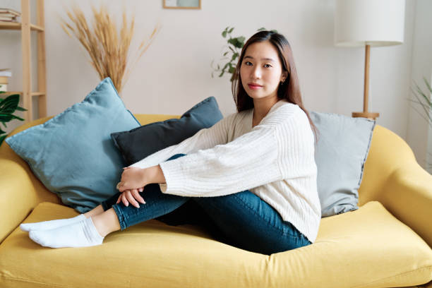 istock Young woman sitting on sofa 1452663567