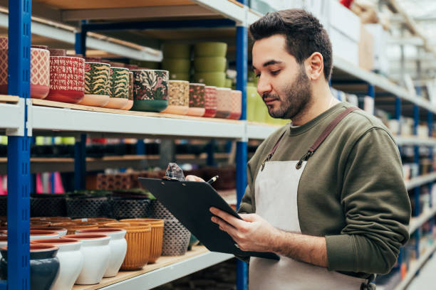 istock Male florist checking flowerpot inventory 1452664128