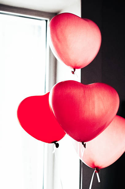istock heart shaped balloons by window 1452665137