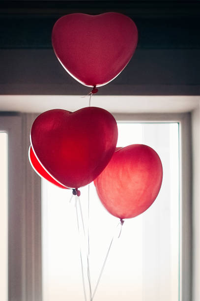 istock Heart shape balloons against window 1452665138