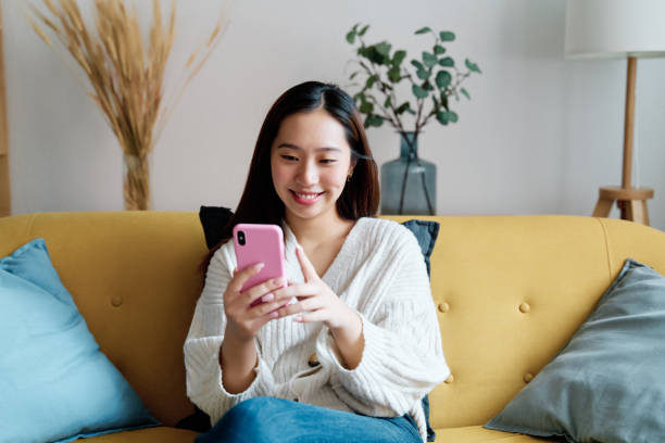 istock Cheerful Asian woman taking selfie on smartphone 1452665152